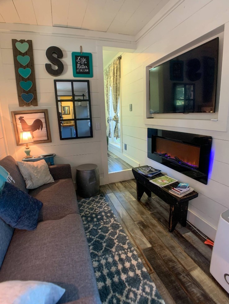 Living room with couch, TV and gas fireplace