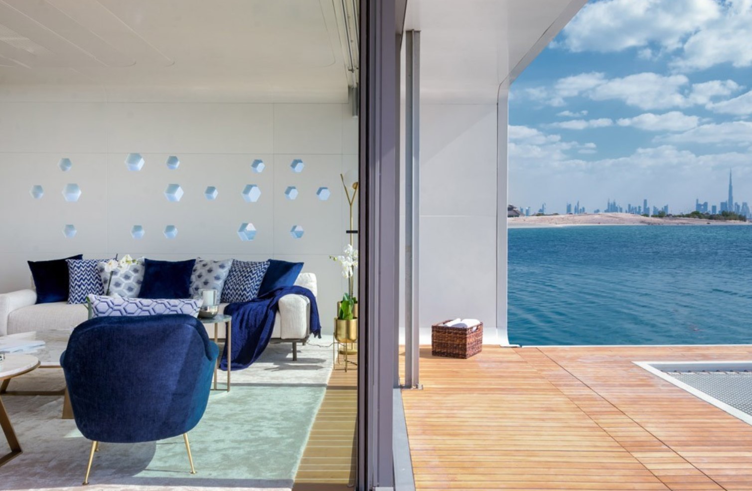 Living room with blue chairs and glass doors that lead to patio