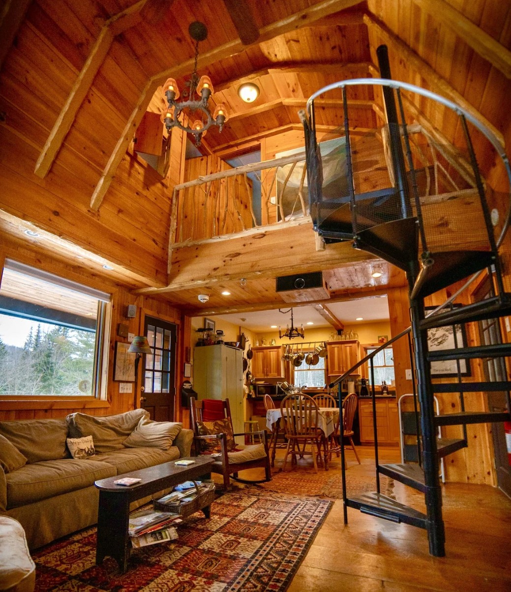 wooden cabin with a spiral stair case in living room