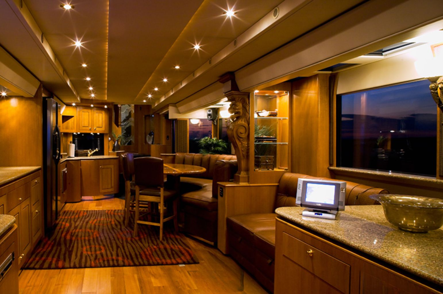 Main living area in motorhome with wooden details and leather couches