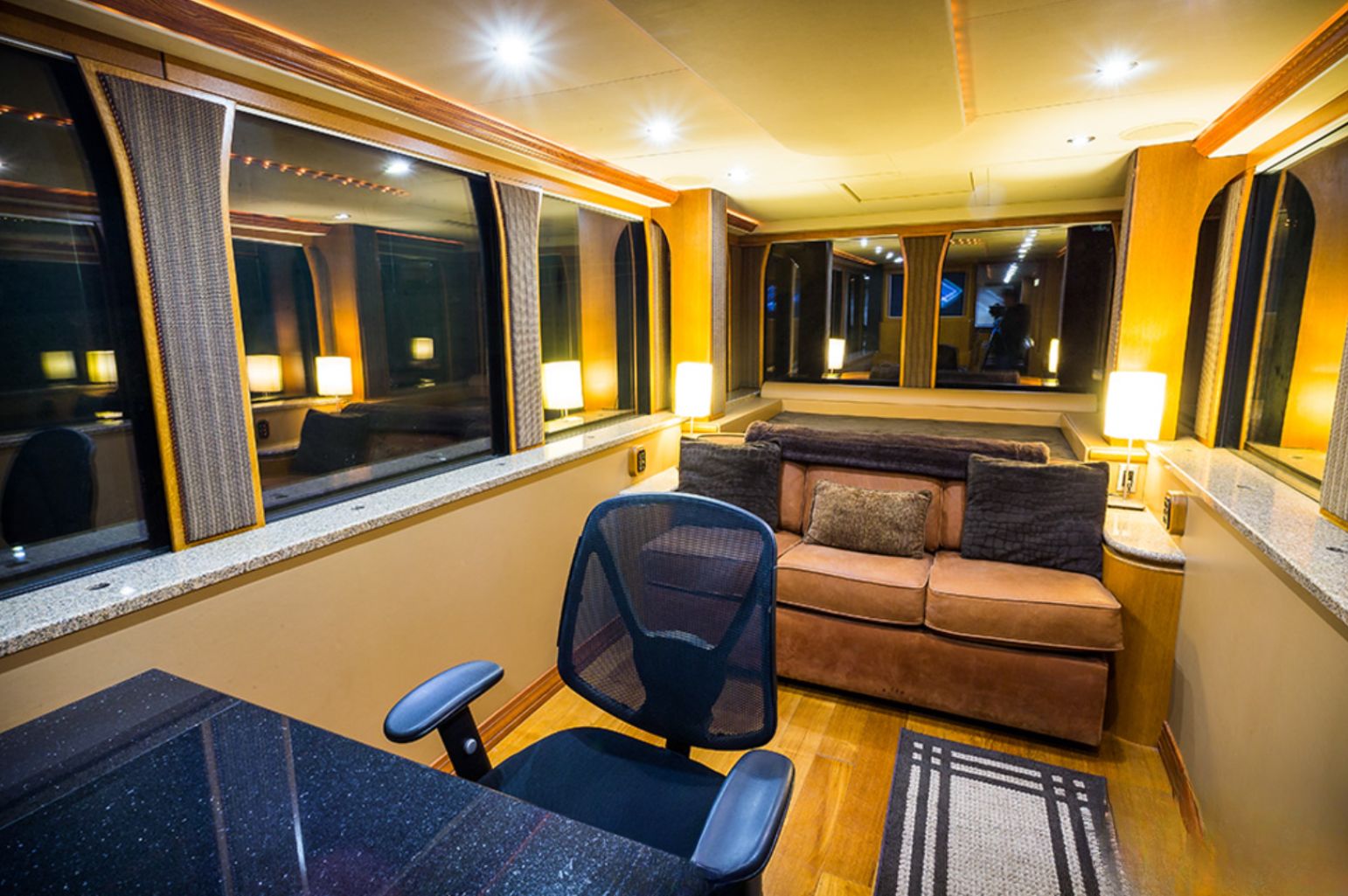 Master bedroom with a leather couch and a built in desk