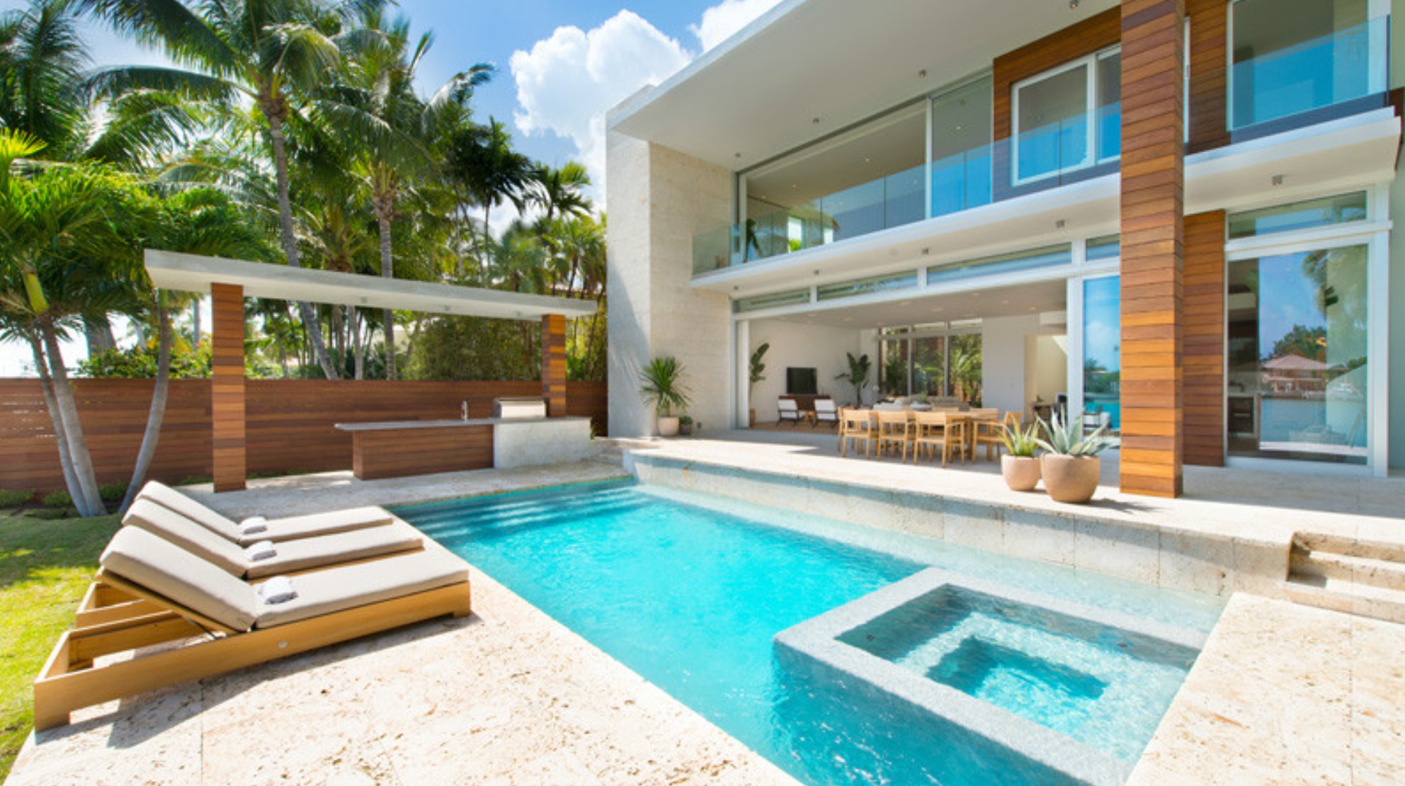 Modern home with pool and deck chairs