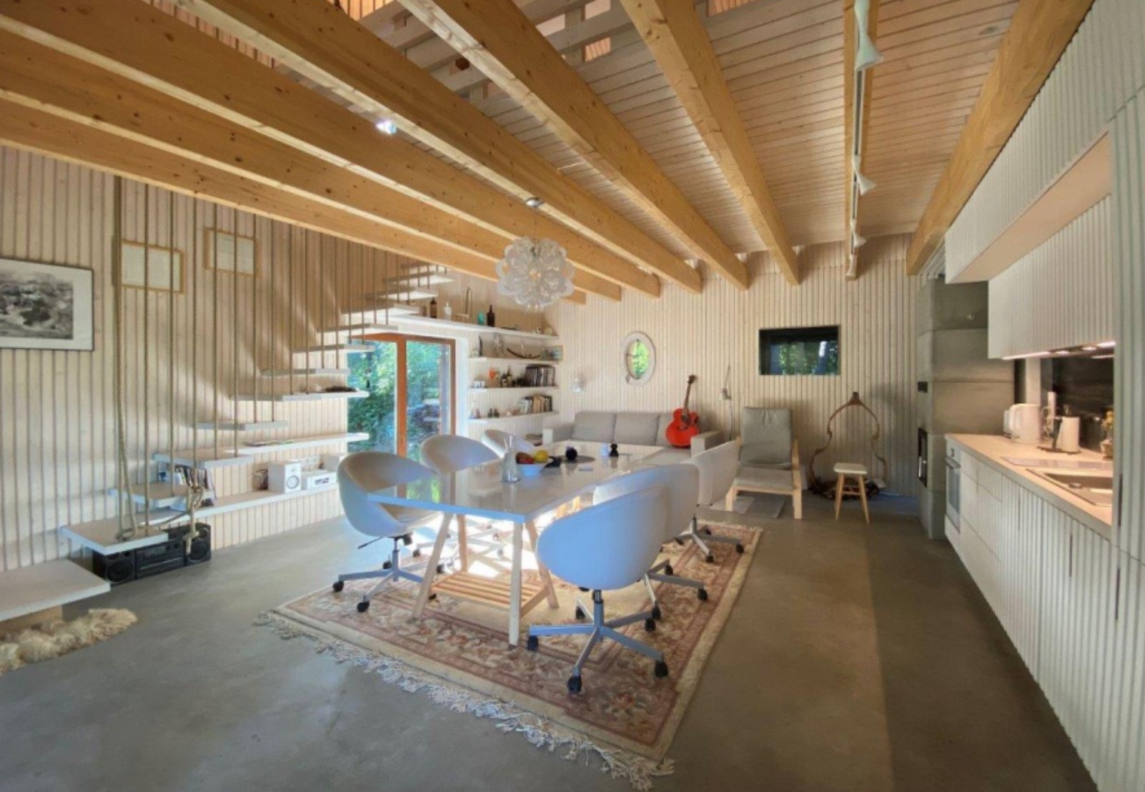 Open concept cabin living room with white wooden boards