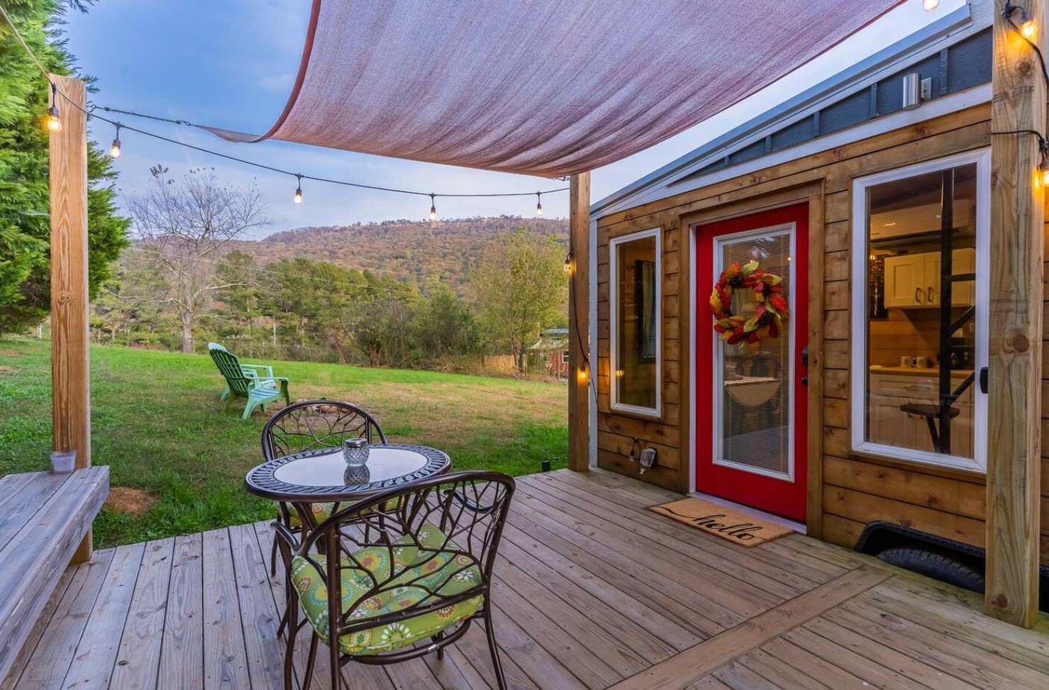 Patio in front of tiny house with a small table