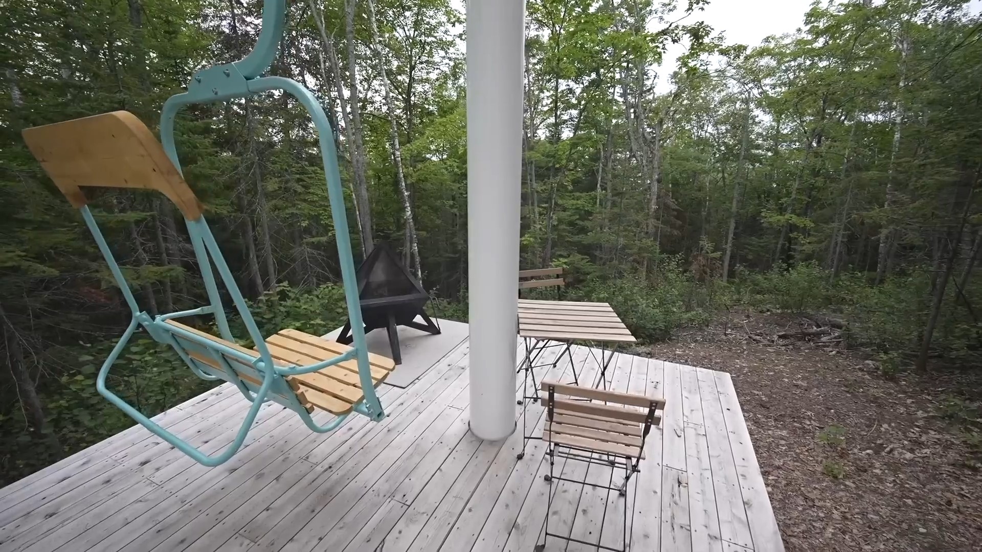 Patio area with grill and a swing