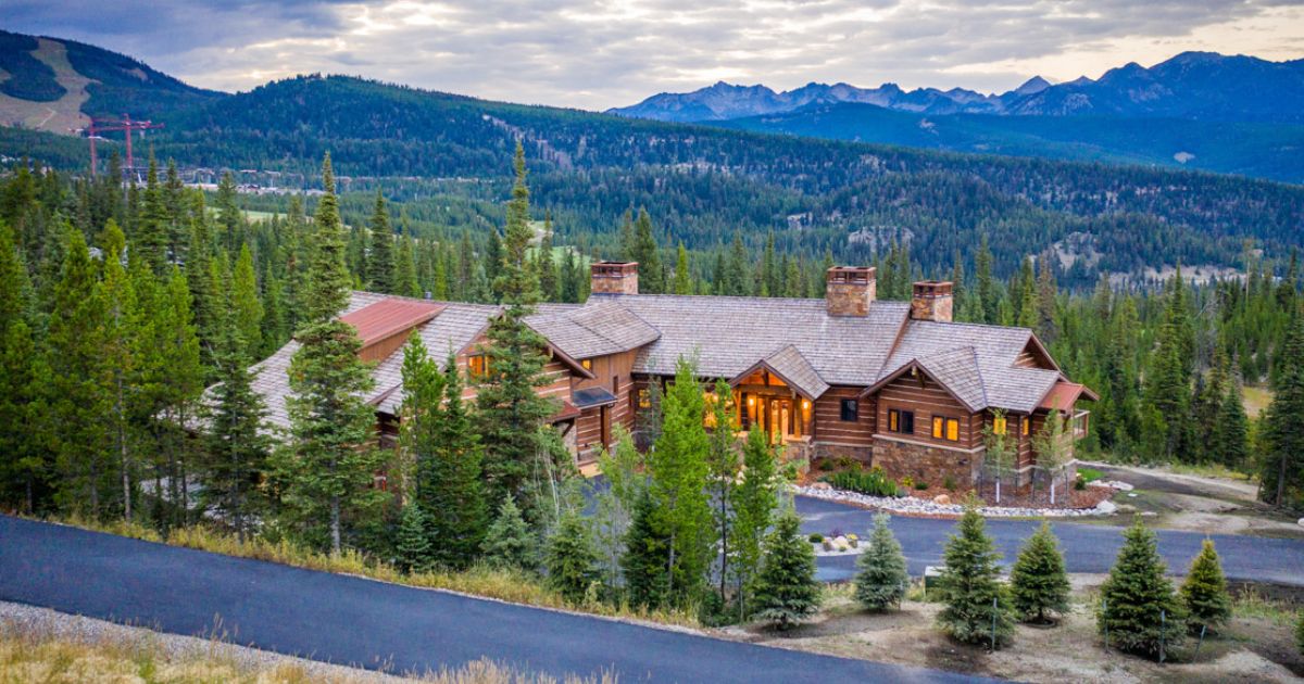 view from above of the mountain valley estate surrounded by pine trees with mountains in the background