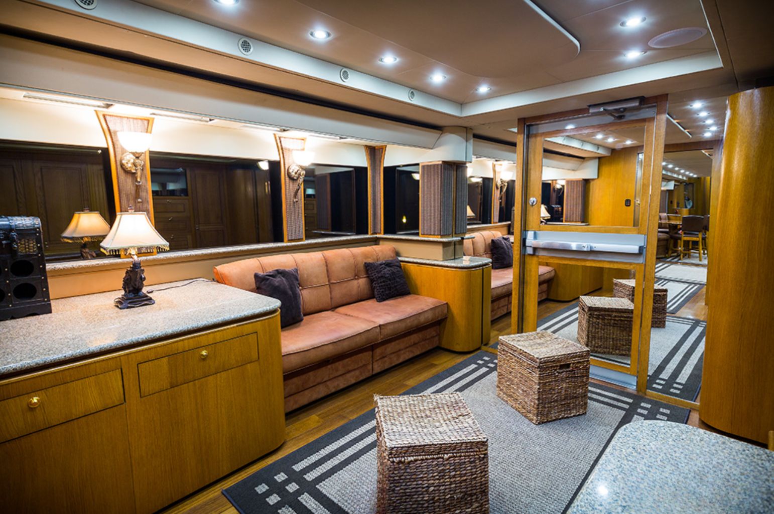 Room in a motorhome with mirrored door and a leather couch