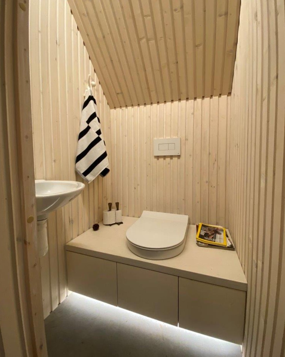 Bathroom in a cabin with white wooden walls