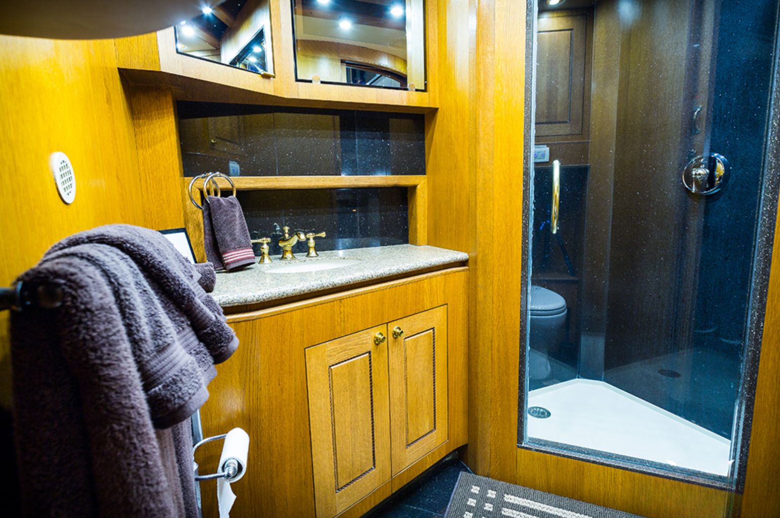 Wooden bathroom with a black marble shower