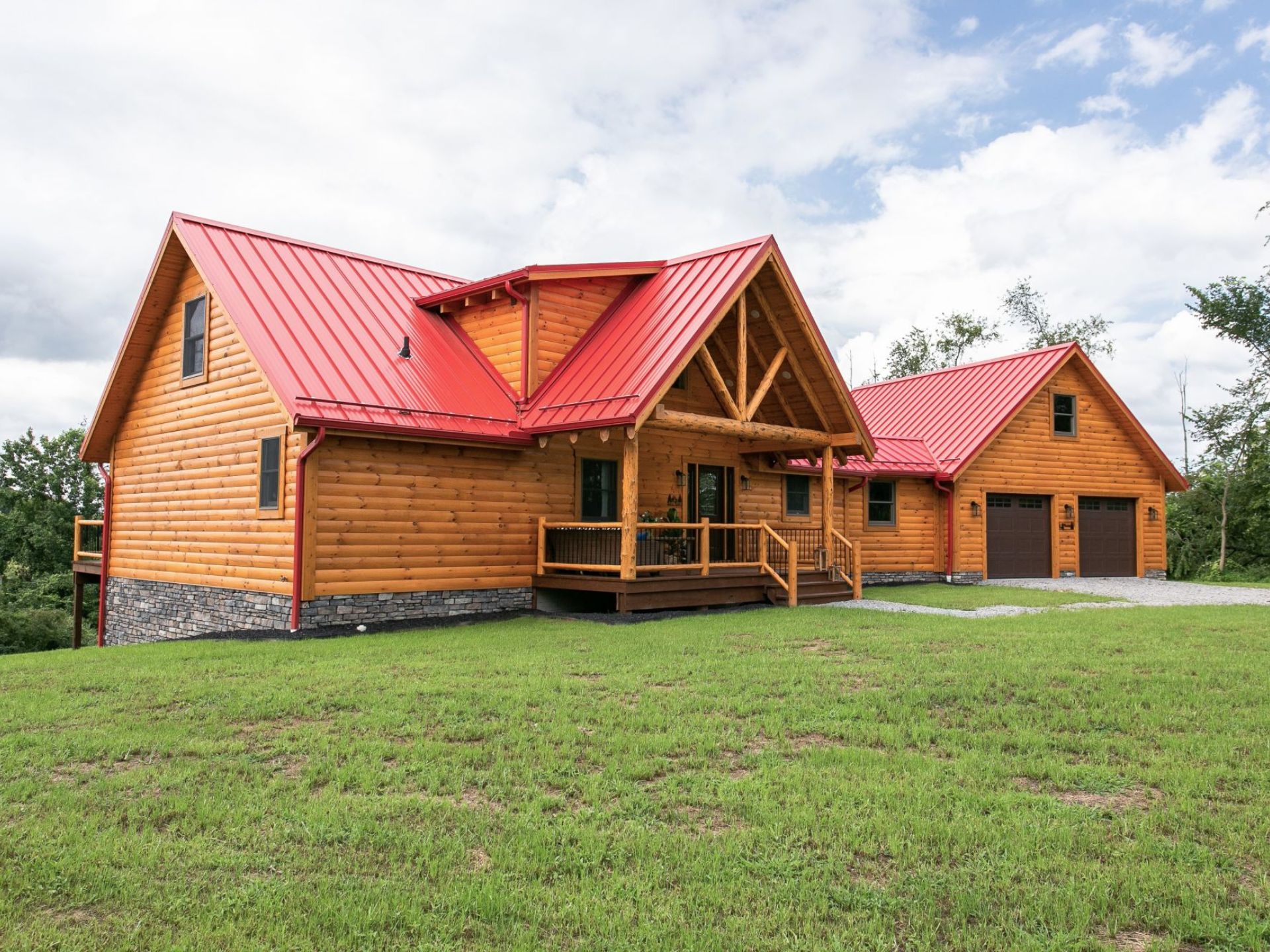 exterior of a cabin with a big land surrounding it