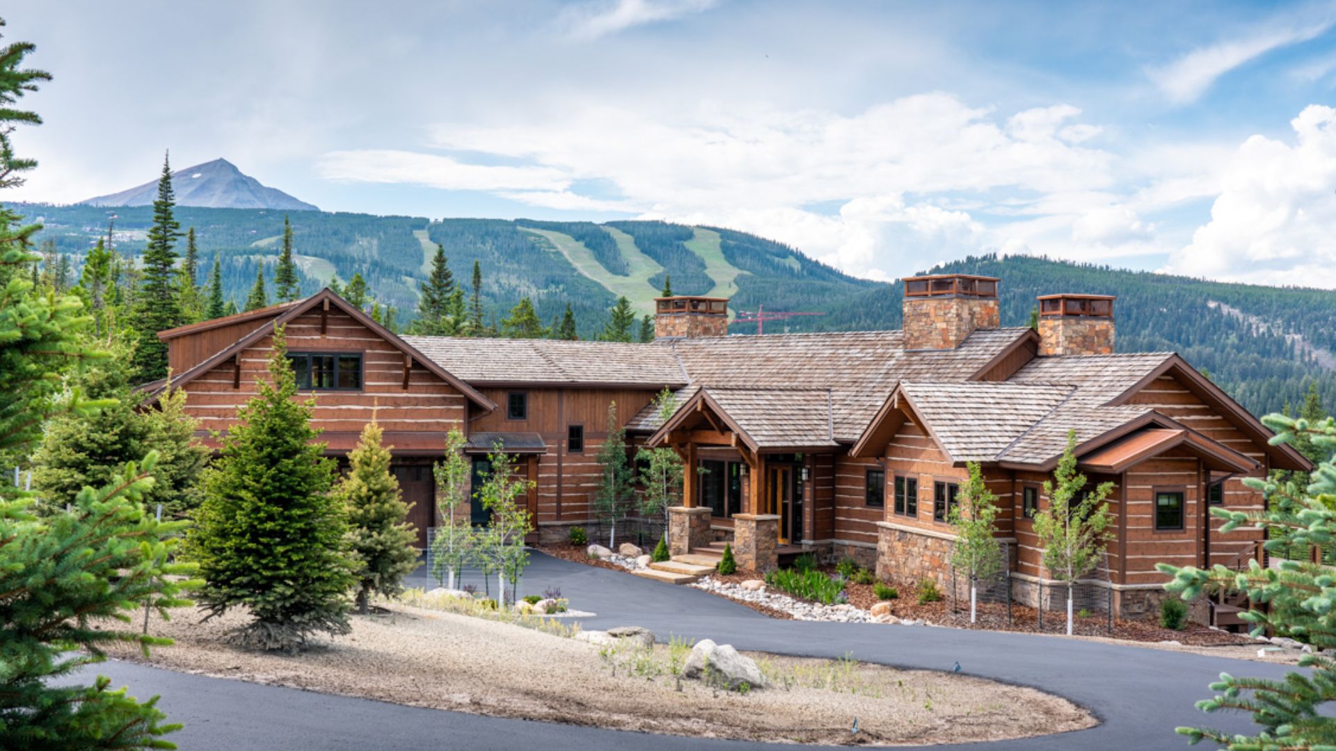 wide driveway up to the luxurious mountain mansion on three levels