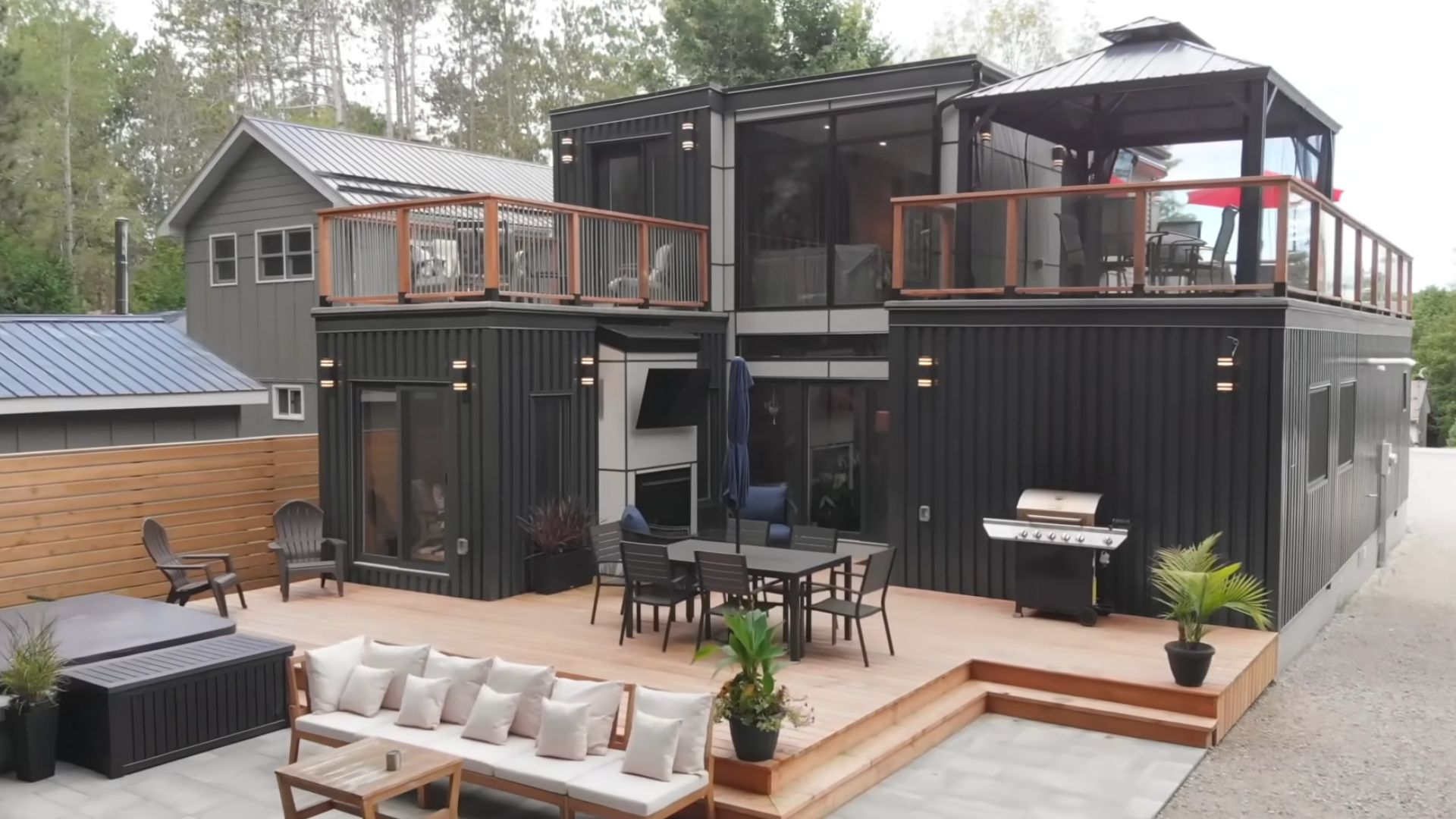 backyard of the container house with a grill and lots of sitting place