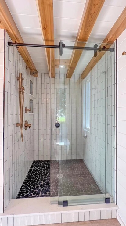 big glass shower with white tiles