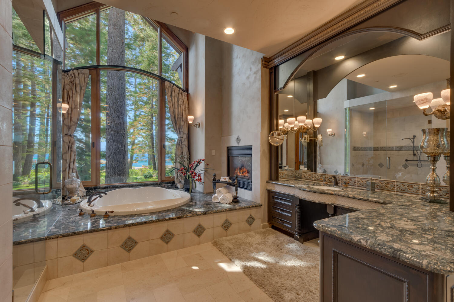 bathroom with a glass shower, white bathtub, l-shaped countertop with a big mirror and a floor to ceiling window