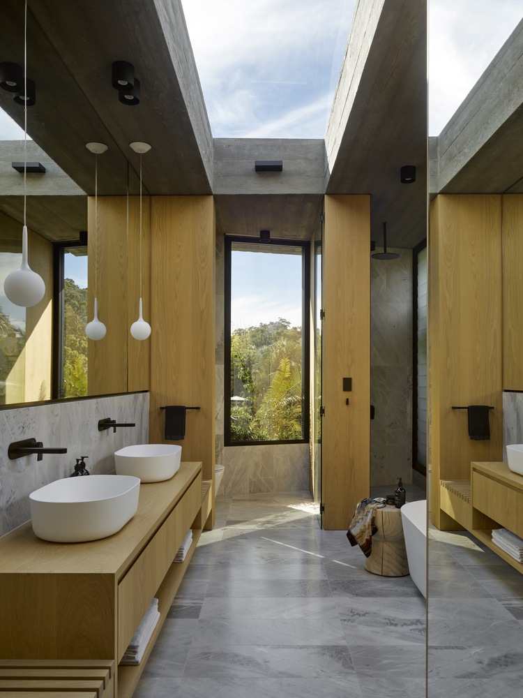 bathroom with a ceiling window, with two sinks under a big mirror