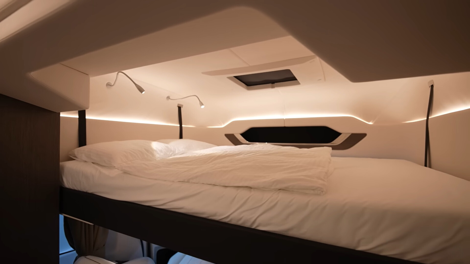 bed that pulls down with a ceiling window and lamps