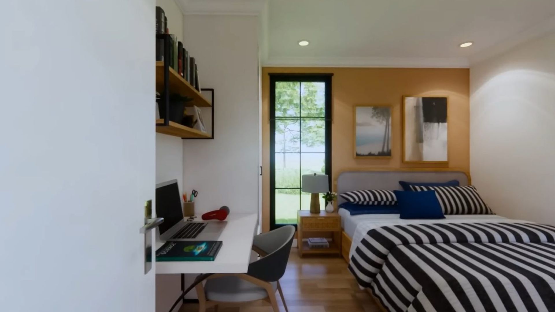 bedroom with a striped beddin, an accent wall, and an office space on the opposite wall