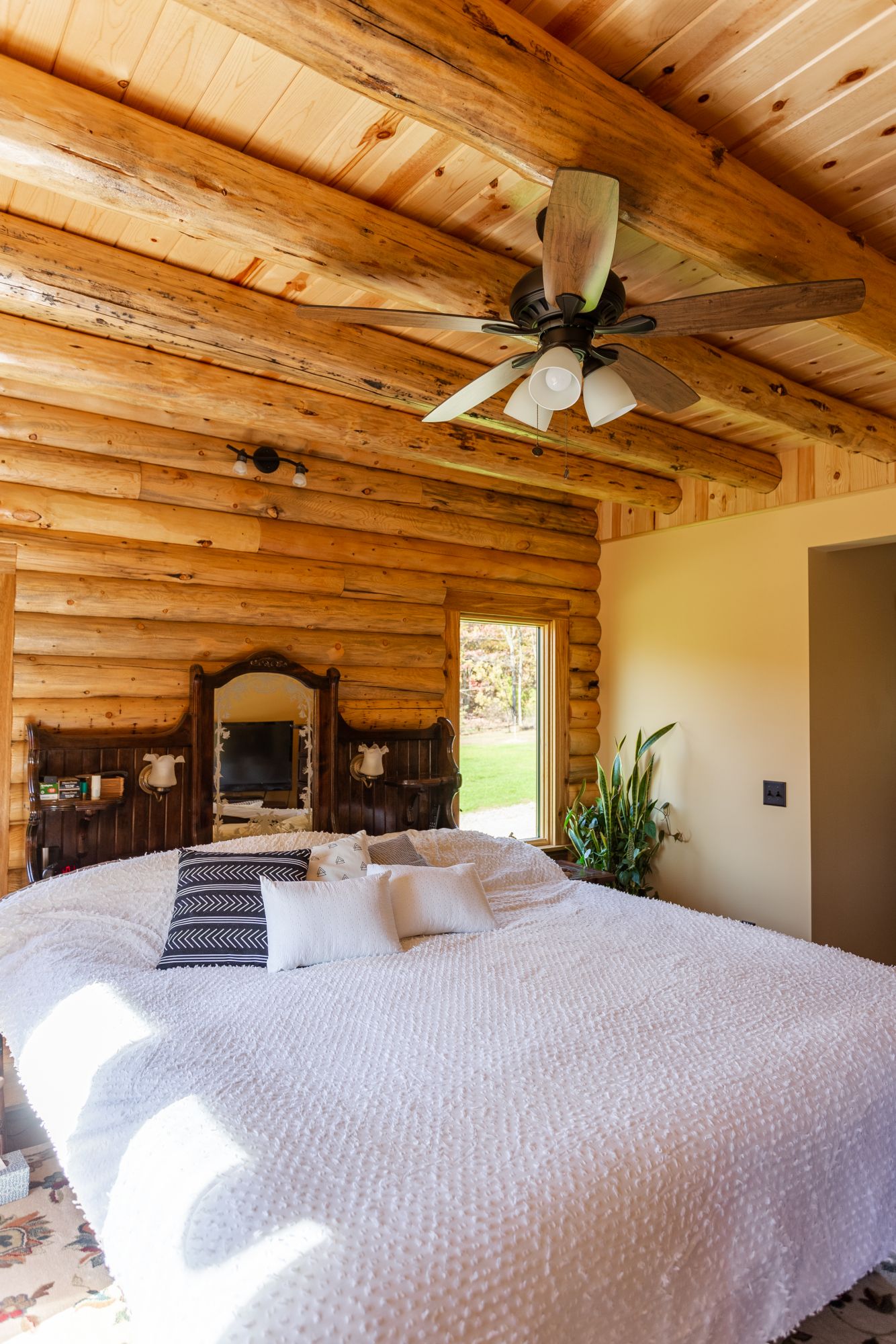 bedroom with a big bed and wooden walls