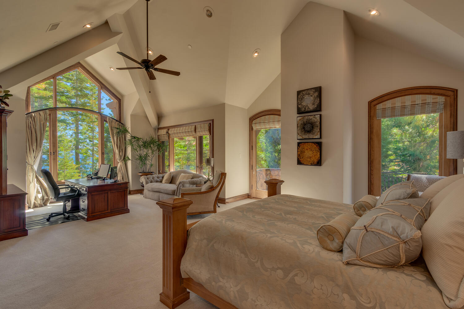 bedroom with a comfy bed, office area inside of a bedroom and a floor to ceiling window