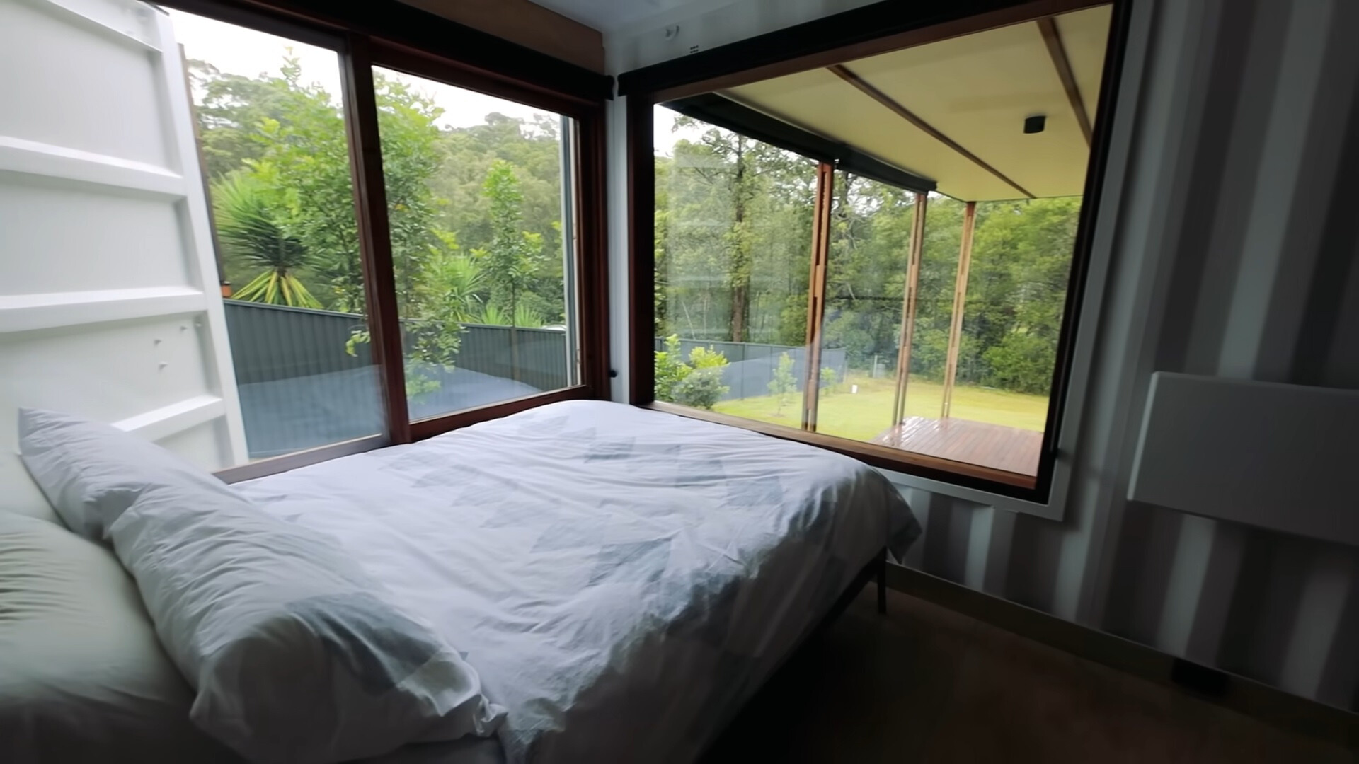 bedroom with big windows around the bed