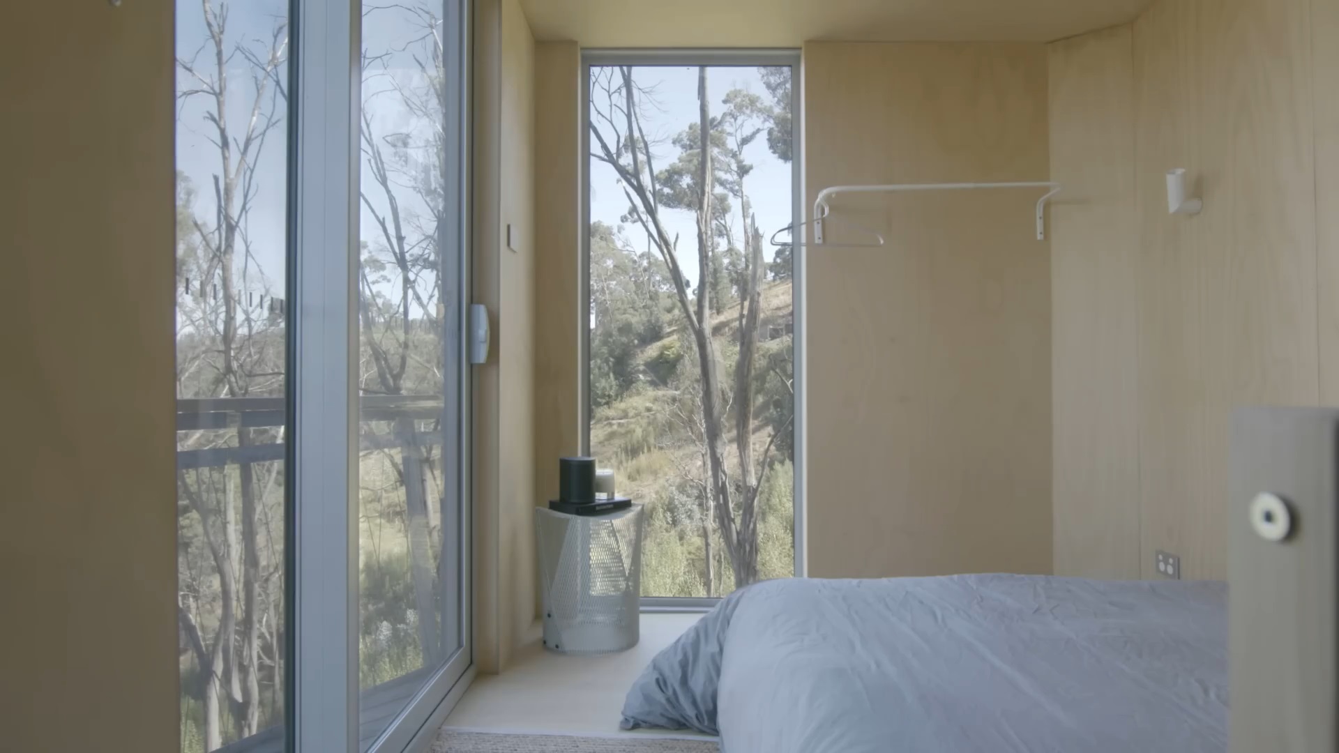 bedroom with floor to ceiling windows and a big bed