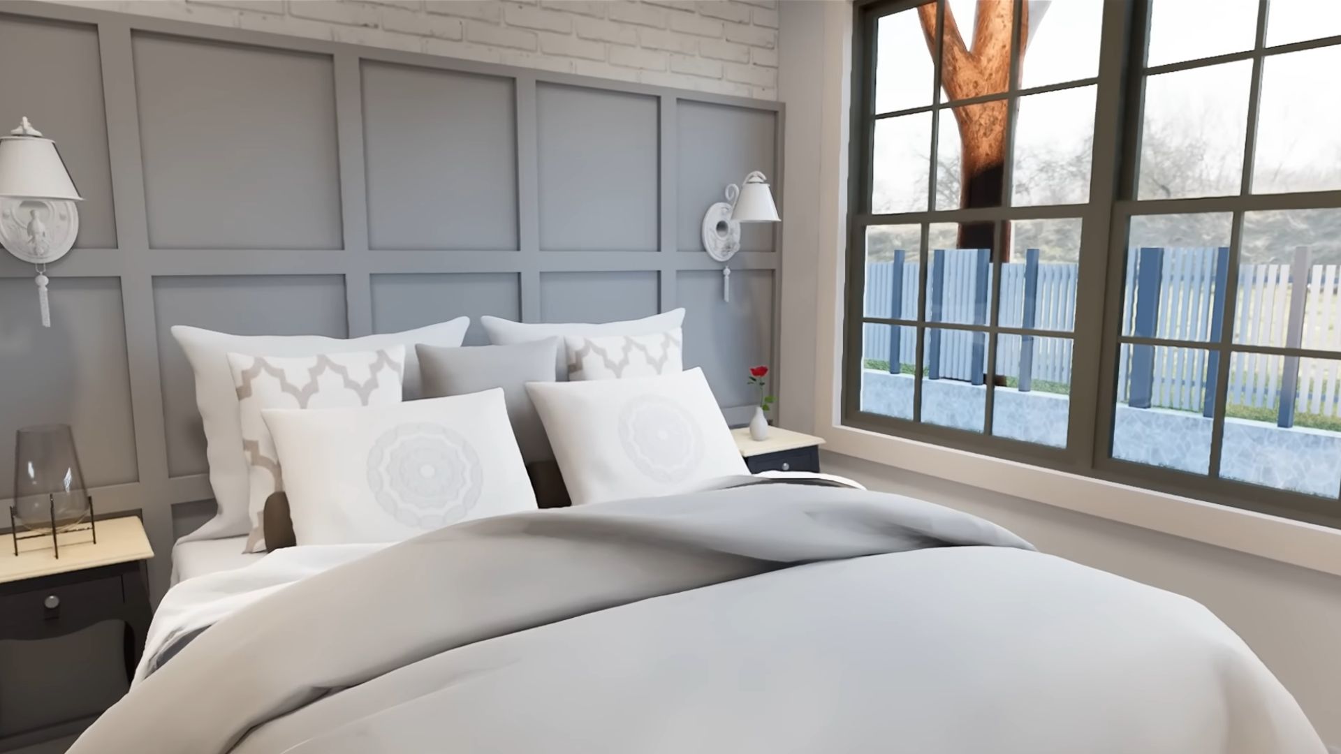 comfy bed next to grey paneling on the wall and lots of natural light