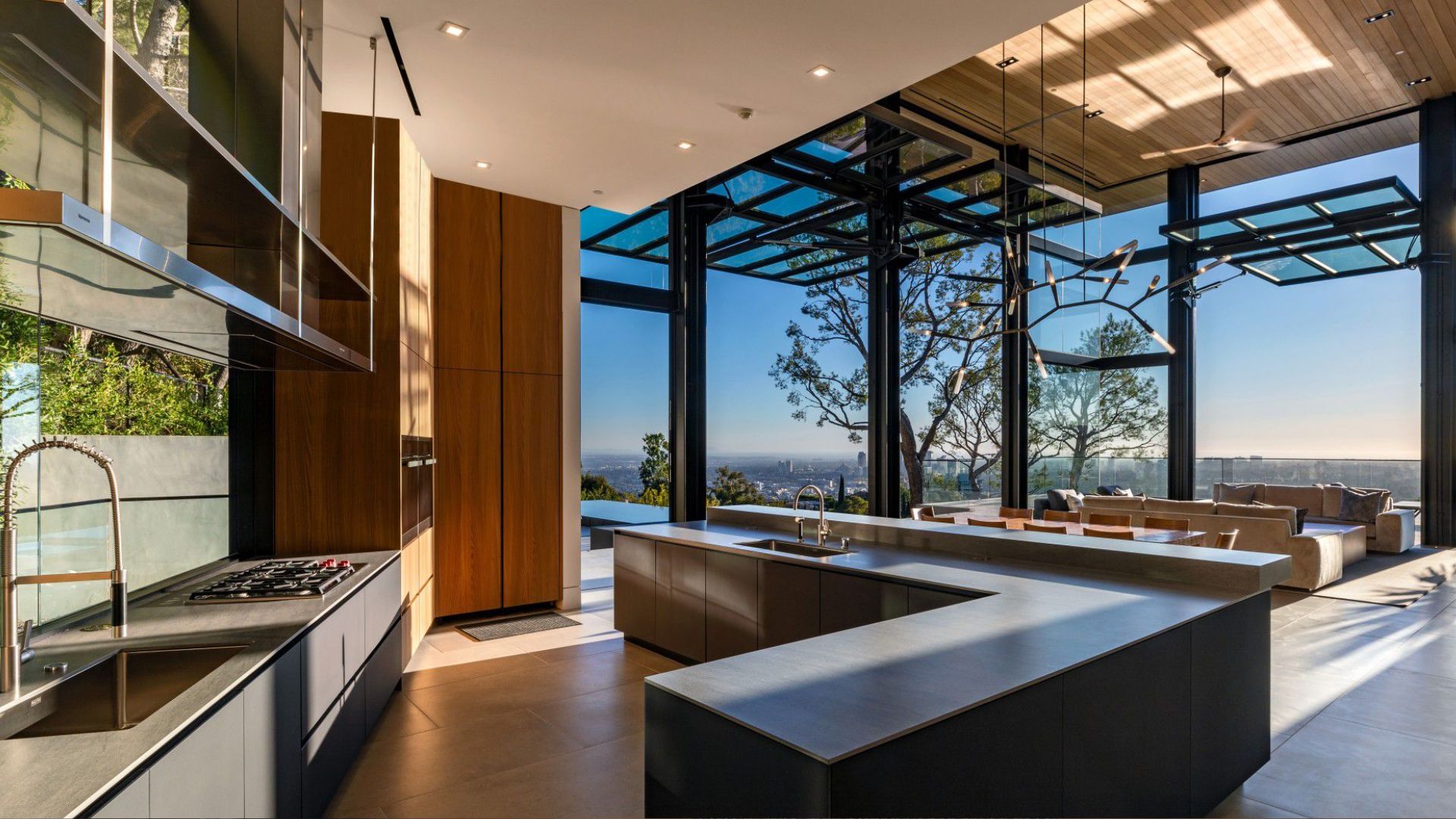 big kitchen in anthracite grey and wood colors overlooking Los Angeles