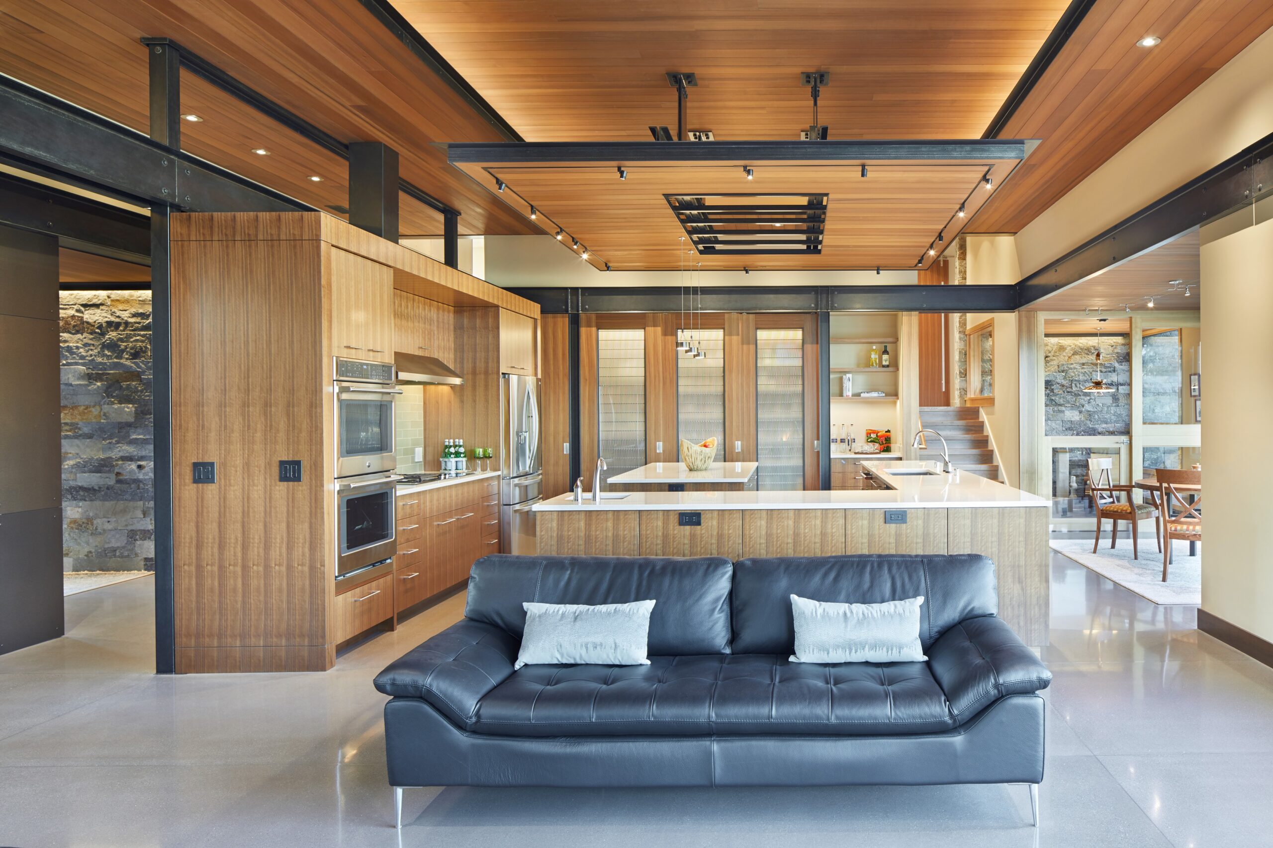 kitchen with brown cabinets and a swuared and an l-shaped island with white countertops