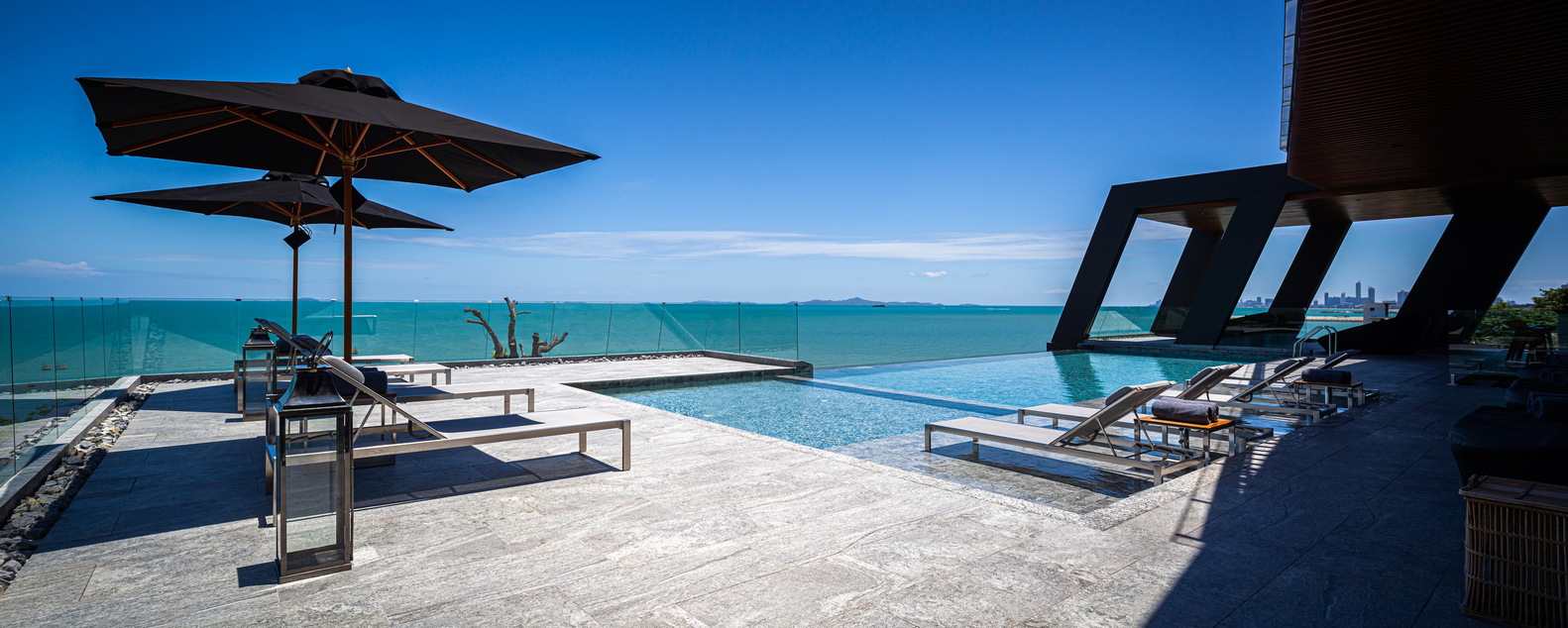 big swimming pool surrounded by deck chairs