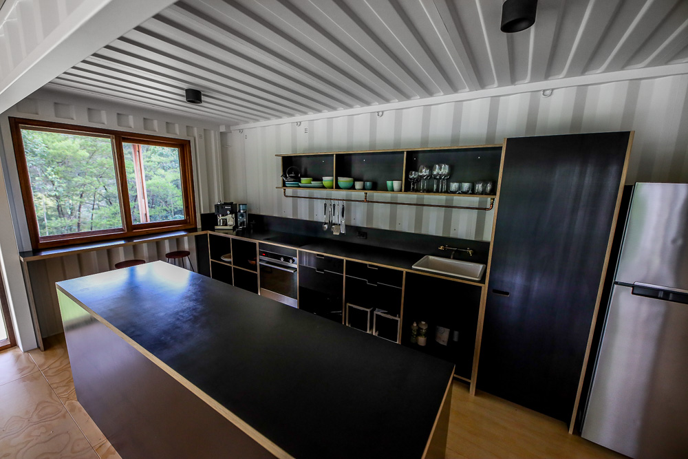 kitchen with black cabinets, black countertop and a black island