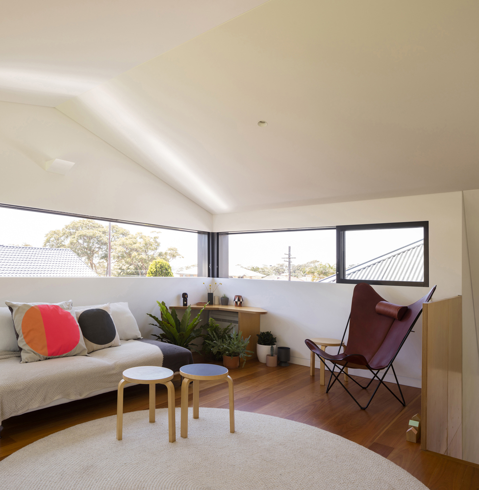 chill upstairs area with a couch, maroon chair, two tiny tables