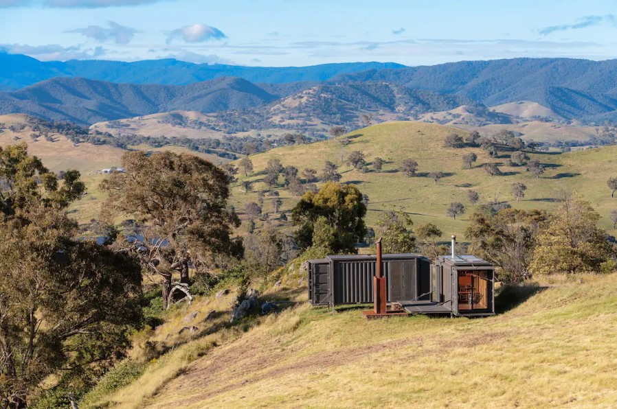 container house from afar surrounded by a lot of land