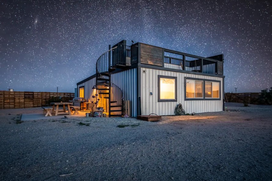 container house in the desert with starry sky