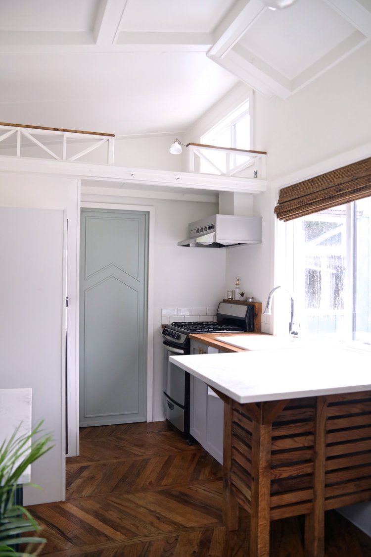 kitchen with brown and white countertops and an empty loft area