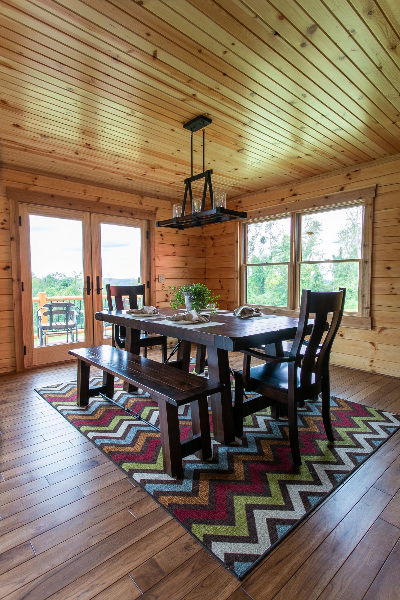 dining room with a dark brown wooden dining table and a bench and chairs