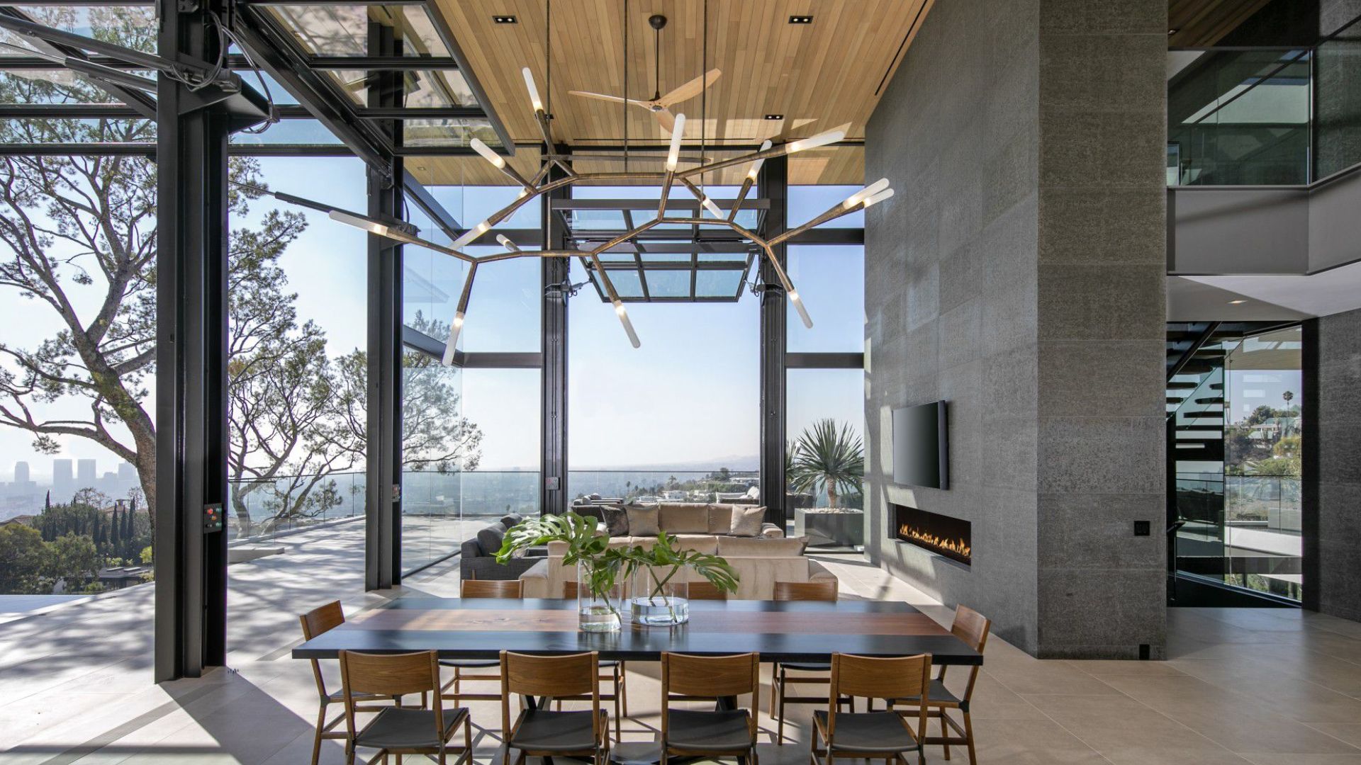 spacious dining room area with a table for 12 and a beatiful lightning body above it