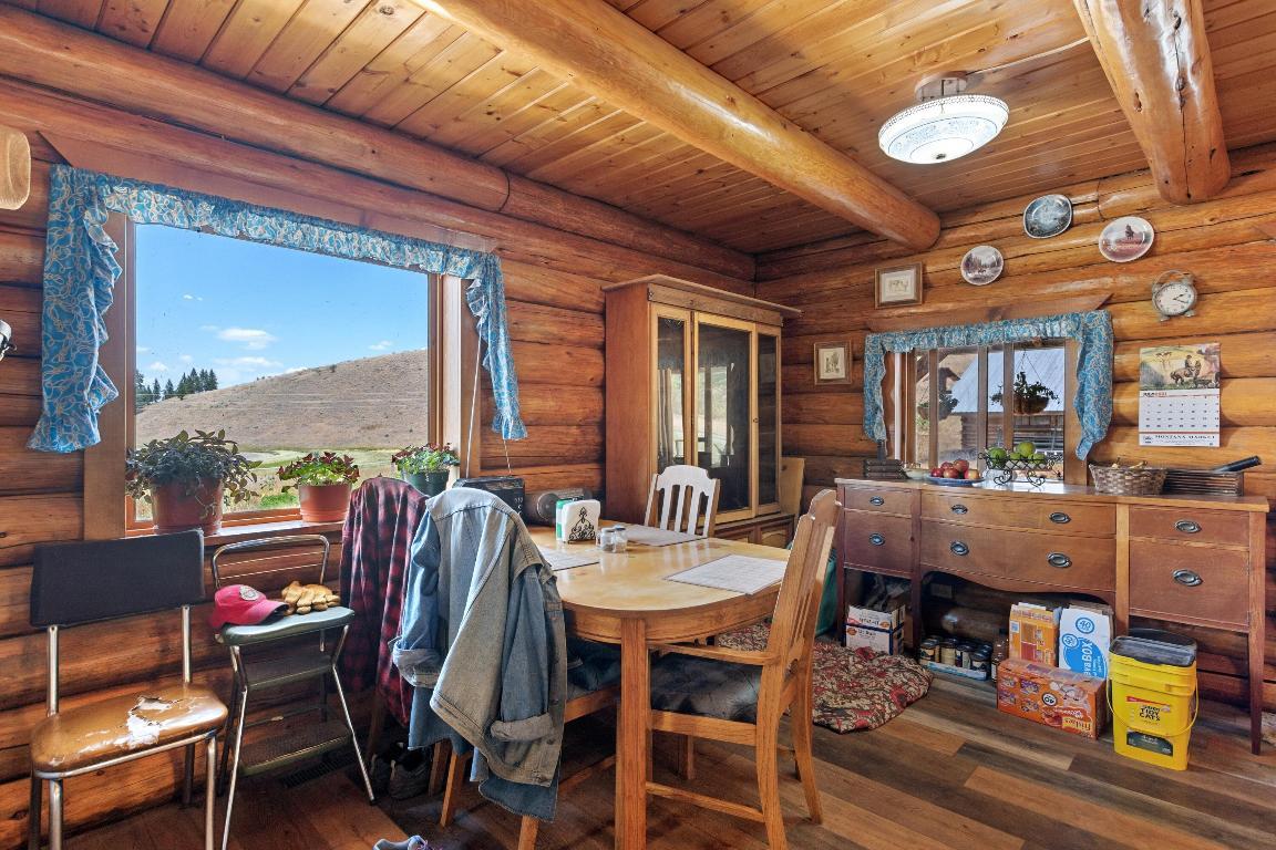 dining room with a brown dining table and brown chairs and a window and a brown amenity