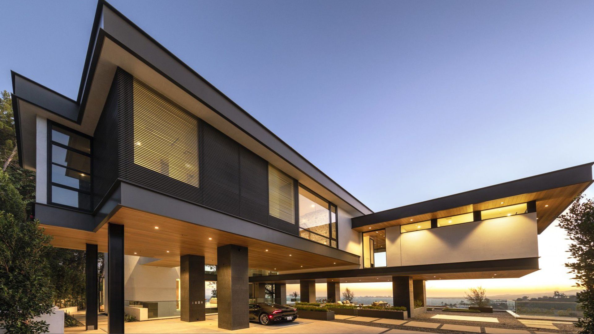 entrance of a luxury house with a second level that floats above it