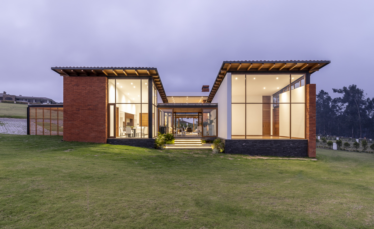 exterior of a modern house surrounded by green land