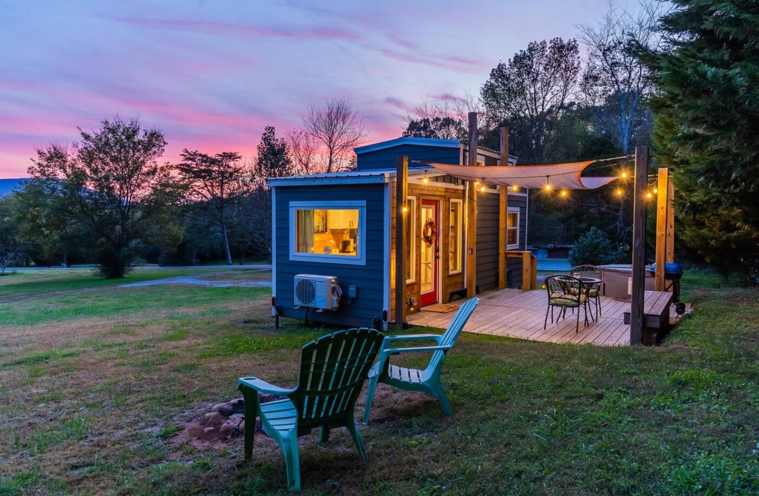 exterior of tiny house with patio and chairs