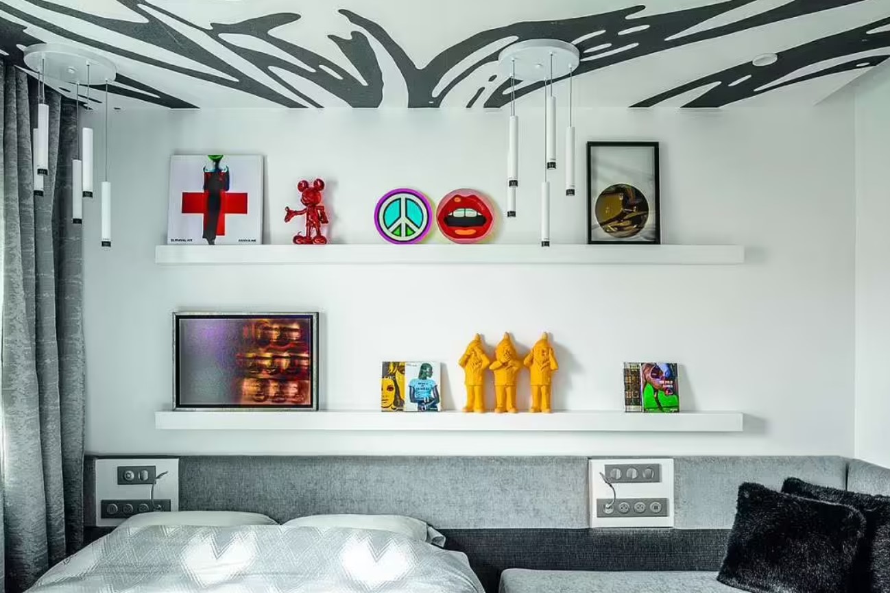 black and white bedroom with colorful figurines and other decor