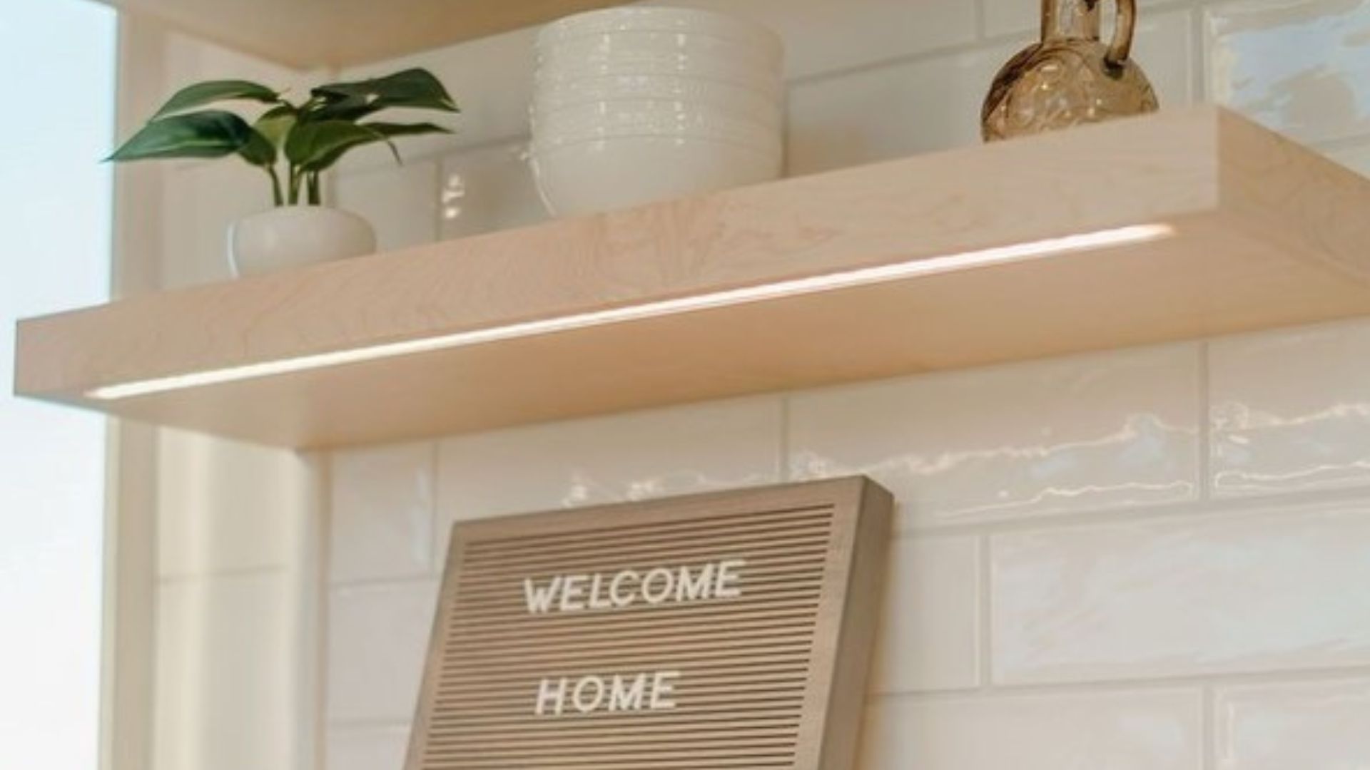 luxurious floating kitchen shelves on white subway tiled wall