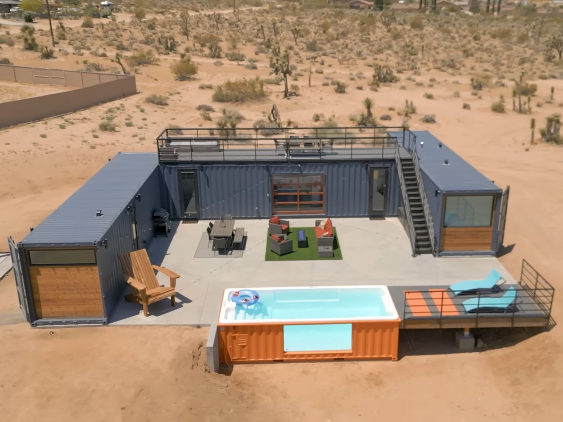 house consisting of three containers and a pool