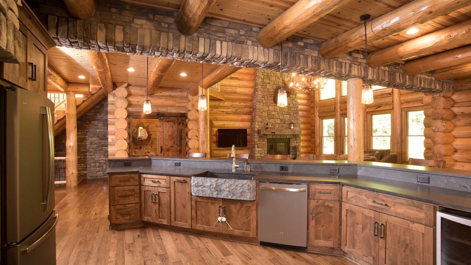 view from the kitchen into the living room with visible appliances and a beautiful stone kitchen sink