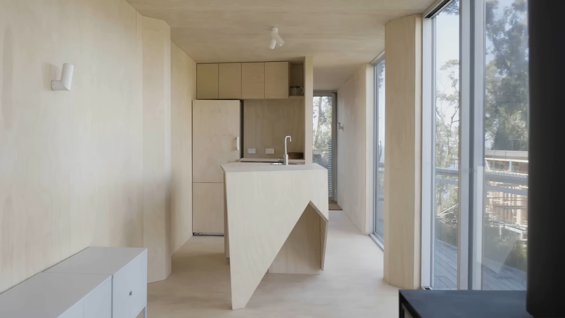 kitchen with beige cabinets and a beige dining table and floor to ceiling windows