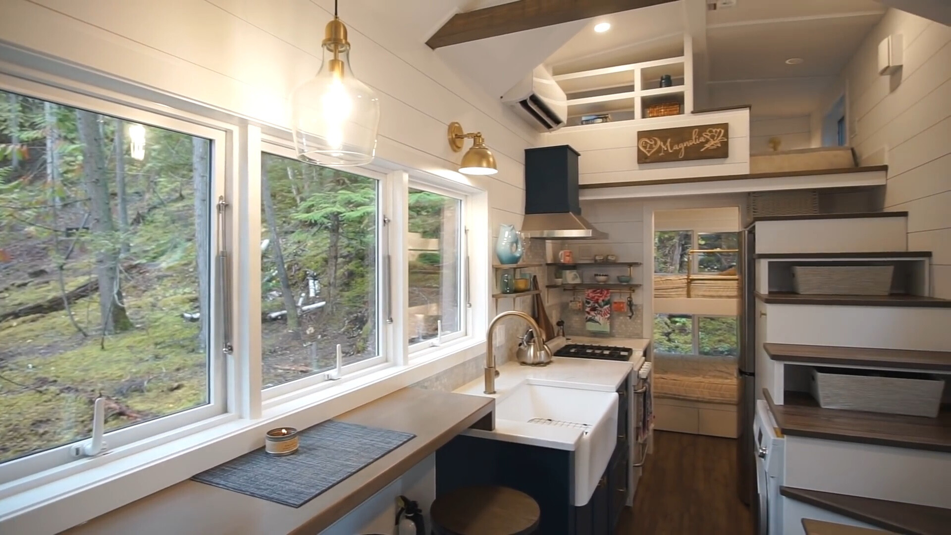 kitchen with shelves, big white sink, white countertop and big windows