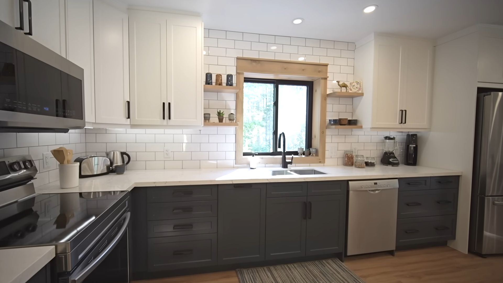 big kitchen in white and blue with marble countertops and modern kitchen appliances