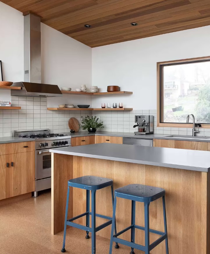 kitchen with brown cabinets, gray ocuntertop and blue bar stools