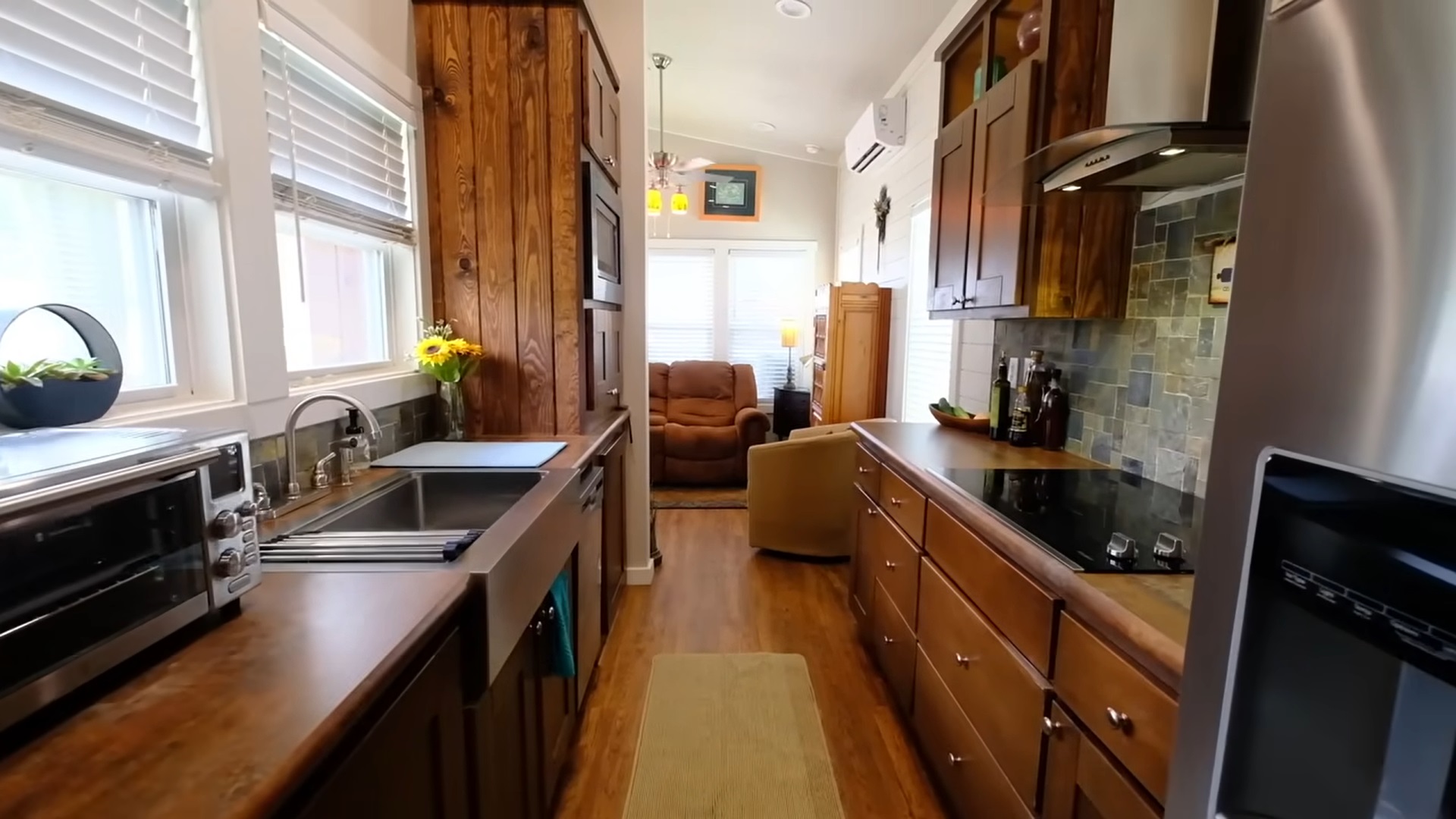 kitchen with brown cabinets and countertops on both sides of the room and a countertop oven