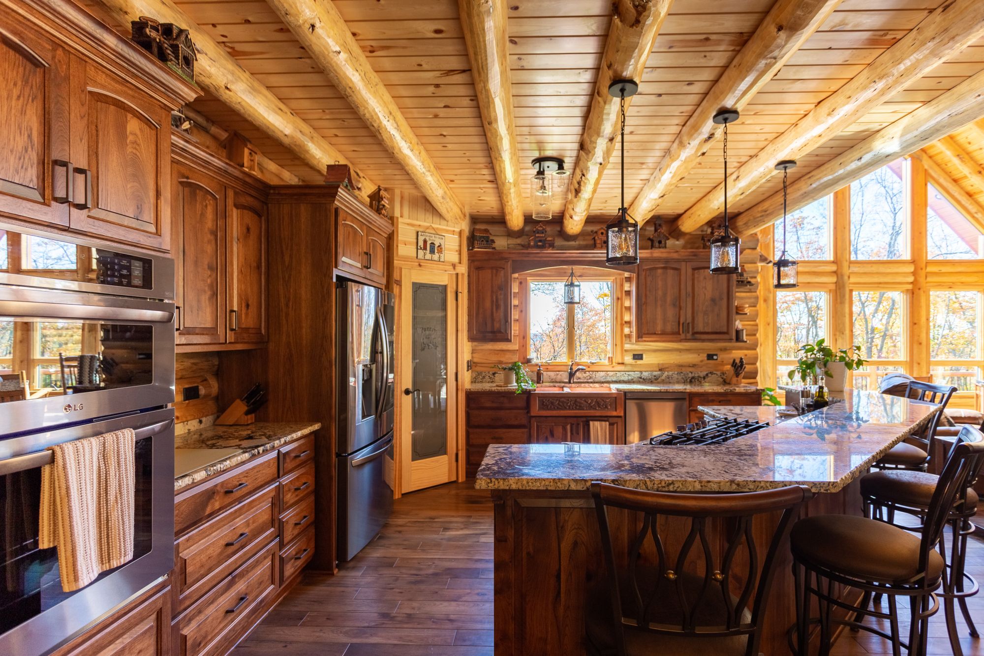 kitchen with brown cabinets and an island with bar stools